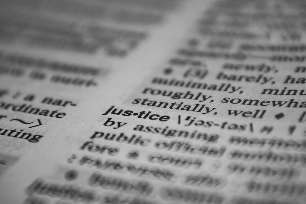 services-01 Selective focus close-up of the word justice in a dictionary, emphasizing concept clarity.